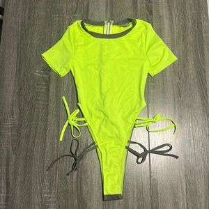 Women’s one piece thong bathing suit with short sleeves .